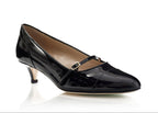 A single black patent leather Mary Jane pump with a kitten heel and a small gold buckle, shown on a white background with a soft reflection.